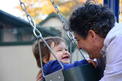 Father by and daughter on swing