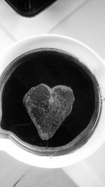 High angle view of heart shape coffee on table