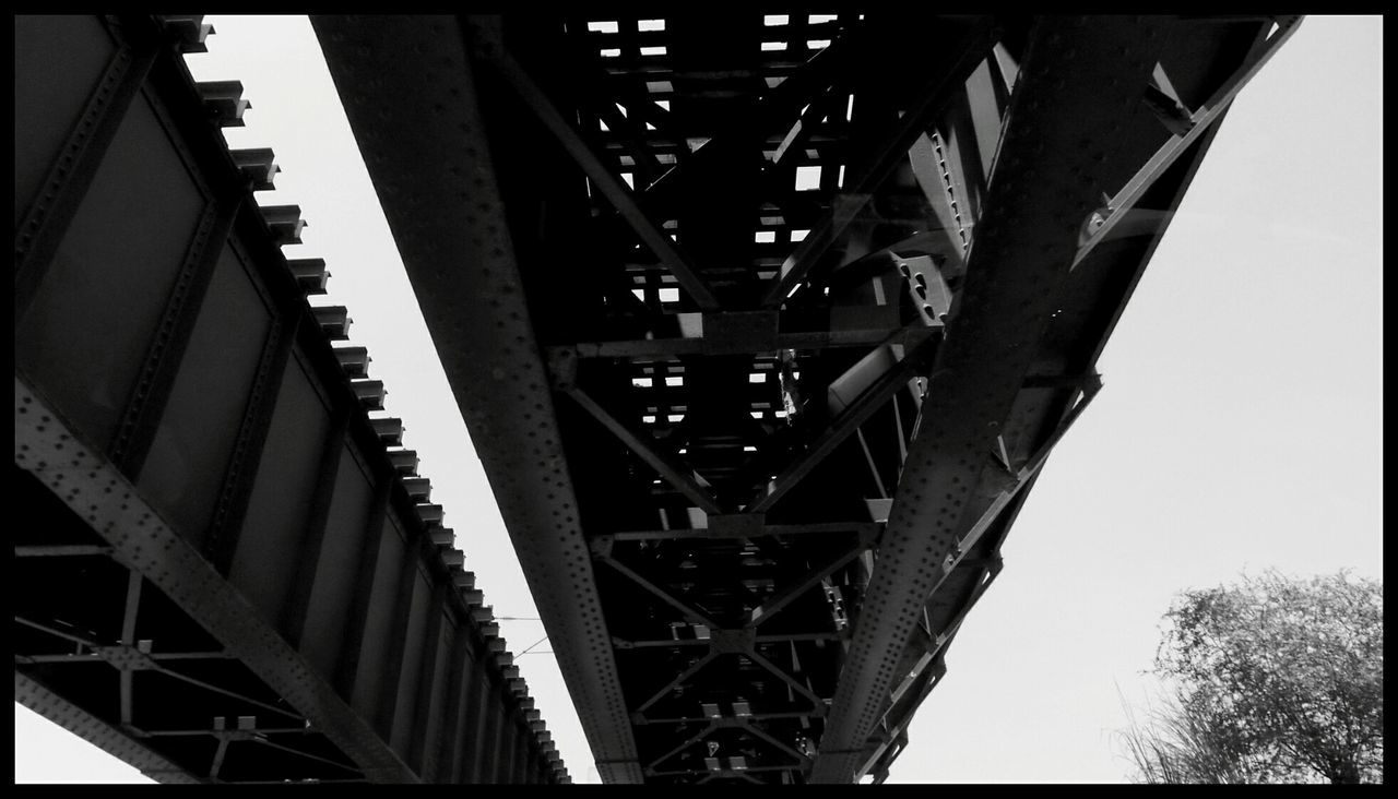 built structure, architecture, low angle view, connection, engineering, metal, bridge - man made structure, diminishing perspective, transportation, clear sky, metallic, in a row, transfer print, the way forward, no people, auto post production filter, day, bridge, vanishing point, outdoors