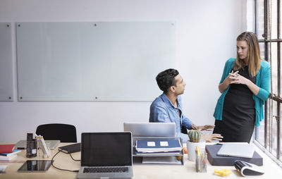 Business people discussing at desk in office