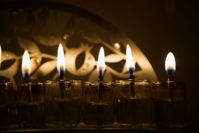 Close-up of burning candles in temple