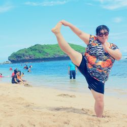 Full length of woman standing on beach