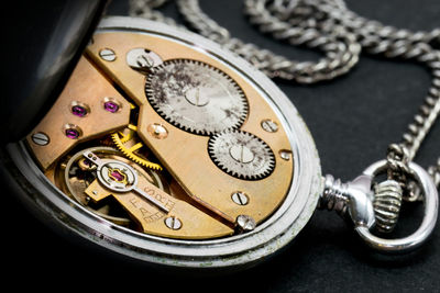 High angle view of open pocket watch on table