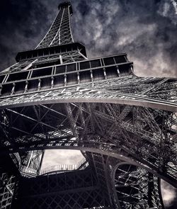 Low angle view of eiffel tower against cloudy sky