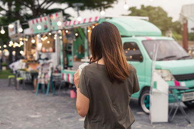 Rear view of woman standing in city