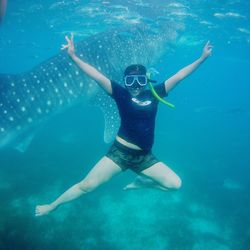 Portrait of woman snorkeling by whale shark undersea