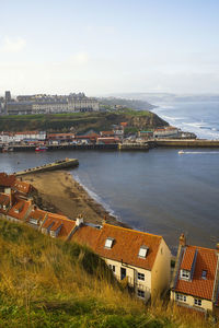 High angle view of whitby townscape by sea against sky