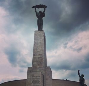 Low angle view of statue against cloudy sky