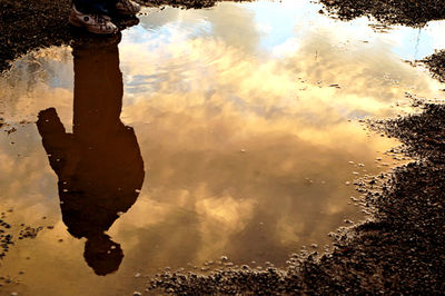 Reflection of sky in puddle