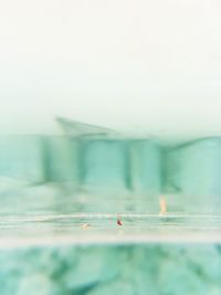 Blurred motion of swimming pool in sea against sky