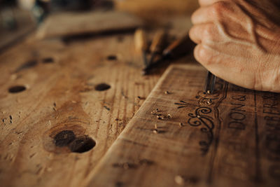 Midsection of person working on wood