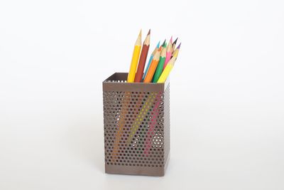 Close-up of multi colored pencils against white background
