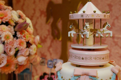 Toy carousel on birthday cake