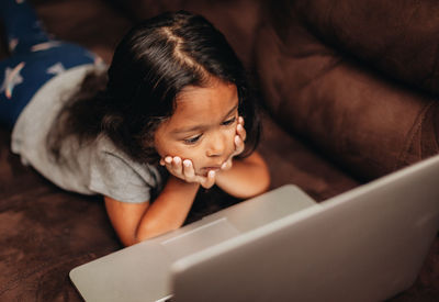 High angle view of girl using mobile phone at home