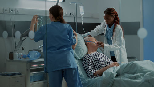 Doctors examining patients at hospital
