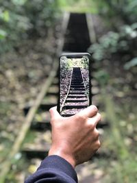 Close-up of hand holding glass against blurred background