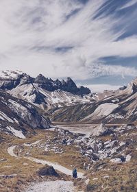 Scenic view of mountains against cloudy sky