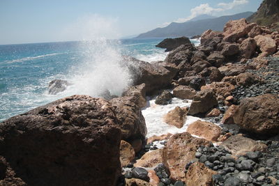 View of rocks at sea shore against sky