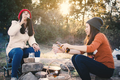 Friends drinking beer on field