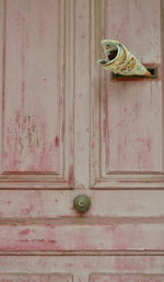 Close-up of old shoes on wooden door