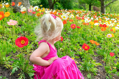 Rear view of girl with pink flowers