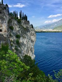 Scenic view of sea and mountains against sky