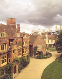 Buildings against cloudy sky