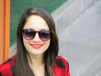 Portrait of smiling young woman in sunglasses