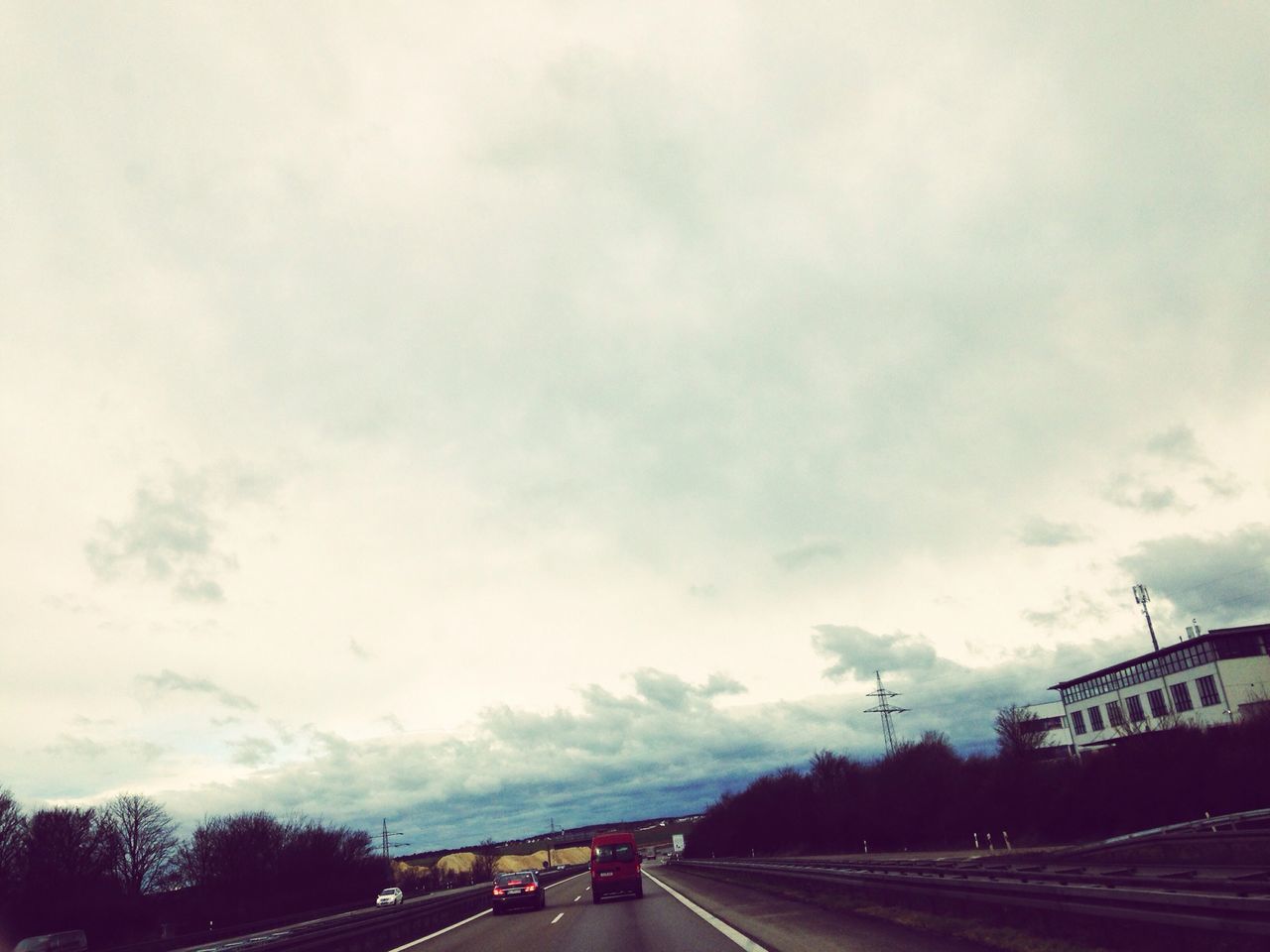 transportation, sky, road, the way forward, cloud - sky, road marking, diminishing perspective, car, vanishing point, cloudy, tree, street, land vehicle, built structure, architecture, cloud, highway, overcast, mode of transport, outdoors