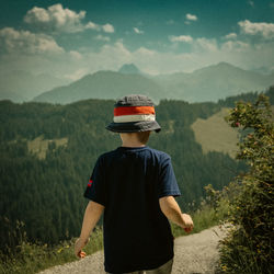 Rear view of woman standing on mountain