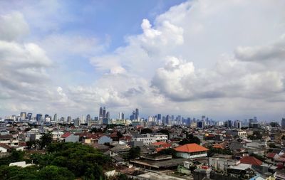 High angle view of city buildings against sky