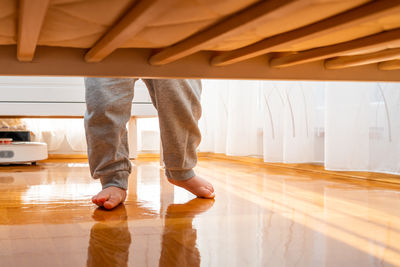 Low section of man walking on floor