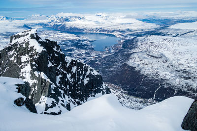 Aerial view of snowcapped mountains against sky outside narvik in arctic norway