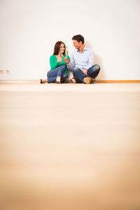 Young couple sitting at home