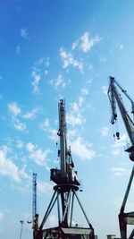 Low angle view of crane against sky