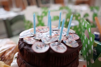 Close-up of birthday cake with candles on table