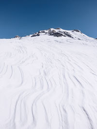 Scenic view of snowcapped mountains against clear sky