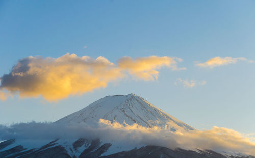 Scenic view of snowcapped mountains against sky during sunset