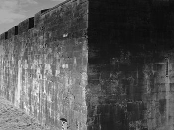 Wall of old building against sky