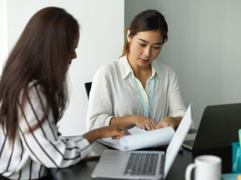 Businesswoman using laptop at home