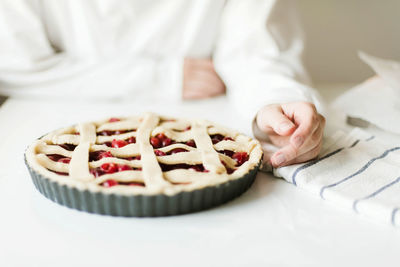 Midsection of person preparing cake