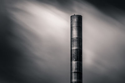 Low angle view of smoke stack against sky