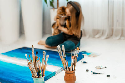 Woman painting on canvas at home