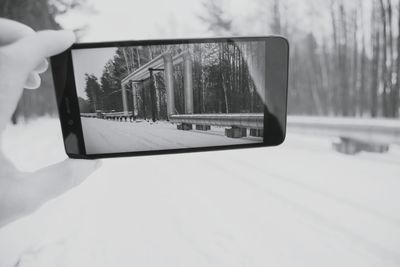 Close-up of car on snowy landscape against sky