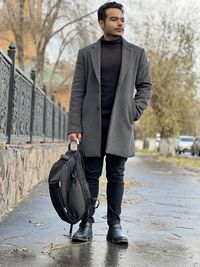 Low section of man standing in puddle