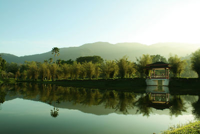 Scenic view of lake and mountains against clear sky