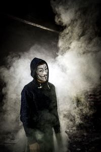 Man wearing mask against smoke