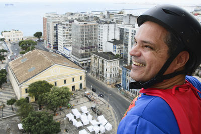 Portrait of young man against buildings