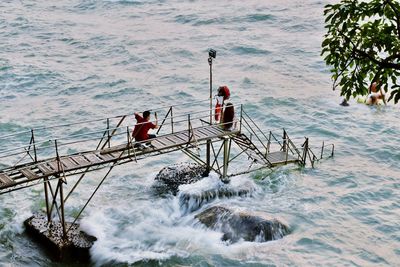 High angle view of men and women by sea