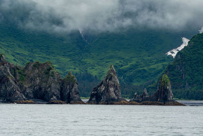Scenic view of sea and mountains against sky